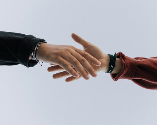 Two hands reaching for each other as a friend tries to figure out how to stop a panic attack