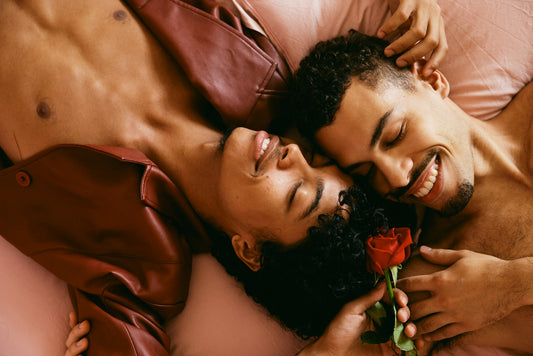 Two men cuddling in bed showing all the green flags in a relationship